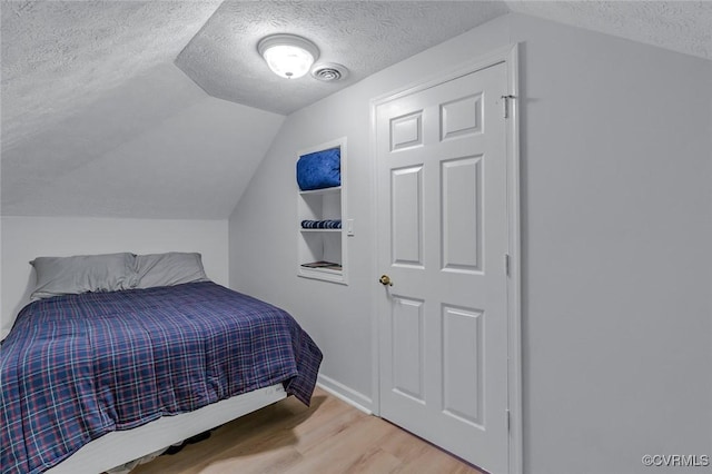 1222 Hull Harbor Rd, Heathsville, VA 22473 - bedroom with a textured ceiling, wood finished floors, and lofted ceiling