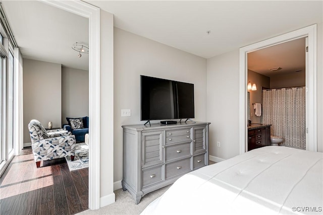 301 Virginia St Unit U806, Richmond, VA 23219 - bedroom featuring baseboards, light wood-style floors, and connected bathroom