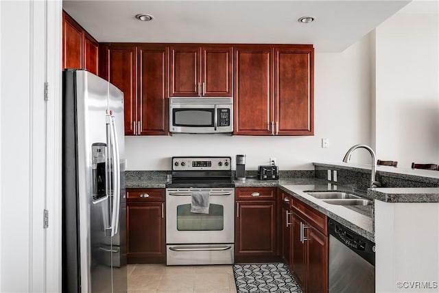 301 Virginia St Unit U806, Richmond, VA 23219 - kitchen with appliances with stainless steel finishes, a sink, reddish brown cabinets, a peninsula, and recessed lighting
