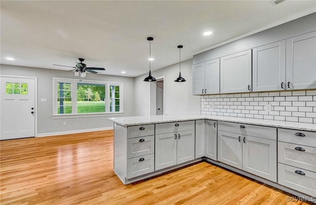 11517 Mount Hermon Rd, Ashland, VA 23005 - kitchen with gray cabinets, a peninsula, ceiling fan, backsplash, and light wood finished floors