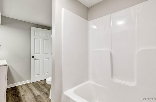 11517 Mount Hermon Rd, Ashland, VA 23005 - bathroom with wood finished floors, toilet, vanity, bathing tub / shower combination, and baseboards