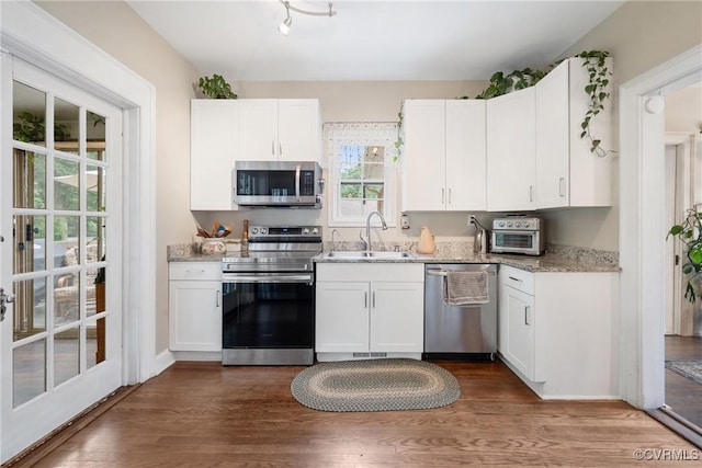 1942 Berkeley Ave, Petersburg, VA 23805 - kitchen featuring appliances with stainless steel finishes, a sink, and white cabinets