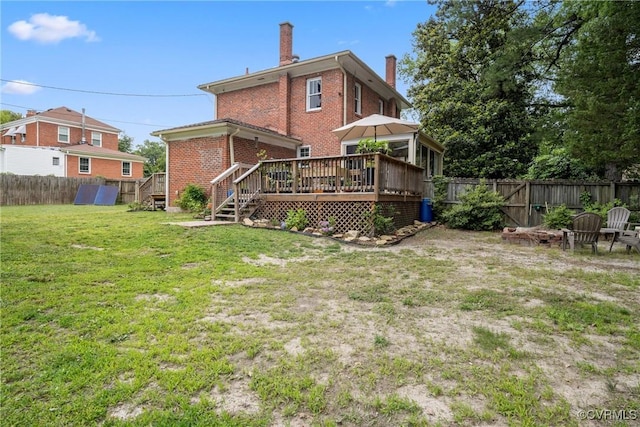 1942 Berkeley Ave, Petersburg, VA 23805 - back of property featuring a chimney, brick siding, and a deck