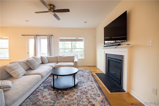 12194 Elnora Ln, Glen Allen, VA 23059 - living room with a ceiling fan, a fireplace with flush hearth, baseboards, and light wood-style flooring
