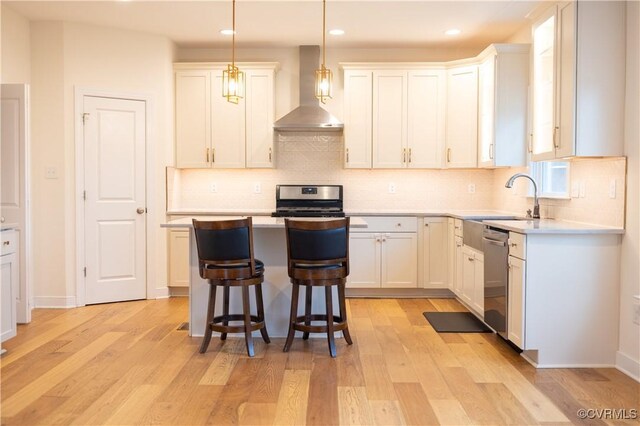 12194 Elnora Ln, Glen Allen, VA 23059 - kitchen with wall chimney exhaust hood, appliances with stainless steel finishes, light wood-style floors, light countertops, and recessed lighting