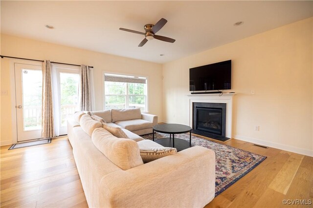 12194 Elnora Ln, Glen Allen, VA 23059 - living area featuring a ceiling fan, wood finished floors, a glass covered fireplace, baseboards, and recessed lighting