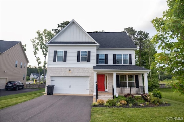 12194 Elnora Ln, Glen Allen, VA 23059 - view of front facade with covered porch, brick siding, asphalt driveway, a front yard, and board and batten siding