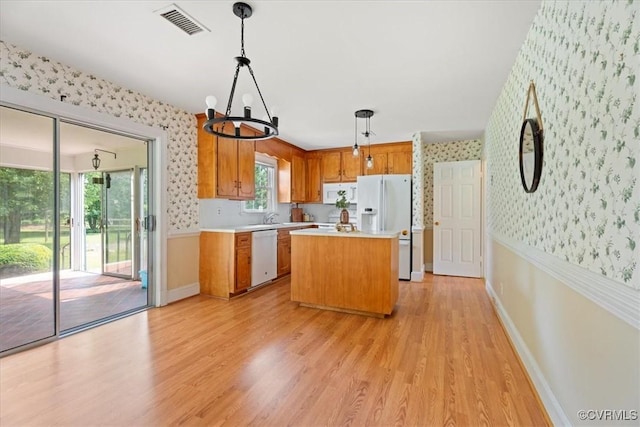 2861 Three Bridge Rd, Powhatan, VA 23139 - kitchen featuring wallpapered walls, white appliances, light countertops, a chandelier, and light wood-style flooring