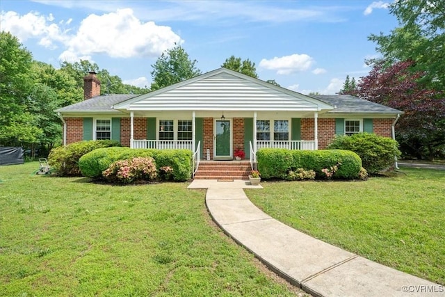 2861 Three Bridge Rd, Powhatan, VA 23139 - view of front of house featuring covered porch, brick siding, a chimney, and a front lawn