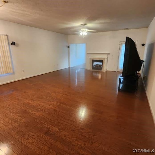 7408 First Landing Ct, Henrico, VA 23231 - unfurnished living room with dark wood-style floors, ceiling fan, and a fireplace