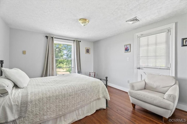 24405 N James Madison Hwy, New Canton, VA 23123 - bedroom featuring dark wood-style floors, baseboards, and a textured ceiling