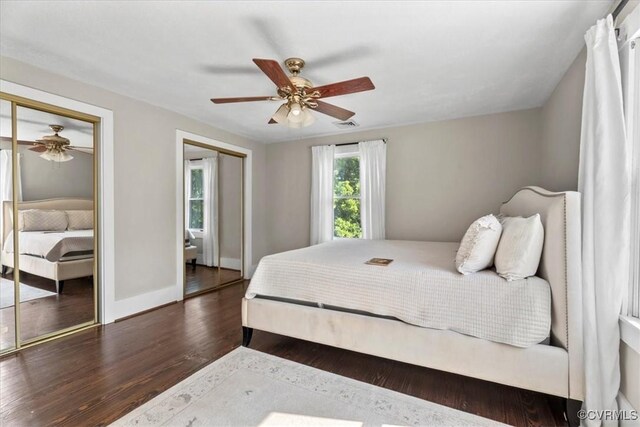 24405 N James Madison Hwy, New Canton, VA 23123 - bedroom featuring multiple closets, dark wood-style floors, baseboards, and a ceiling fan
