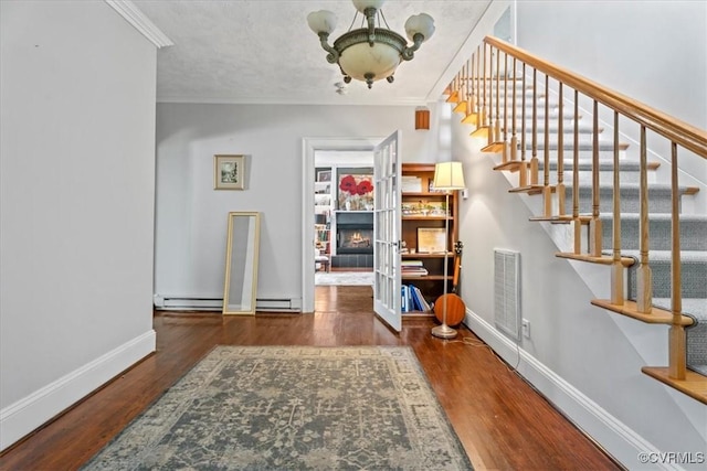 24405 N James Madison Hwy, New Canton, VA 23123 - entrance foyer with wood finished floors, stairway, a chandelier, ornamental molding, and a warm lit fireplace