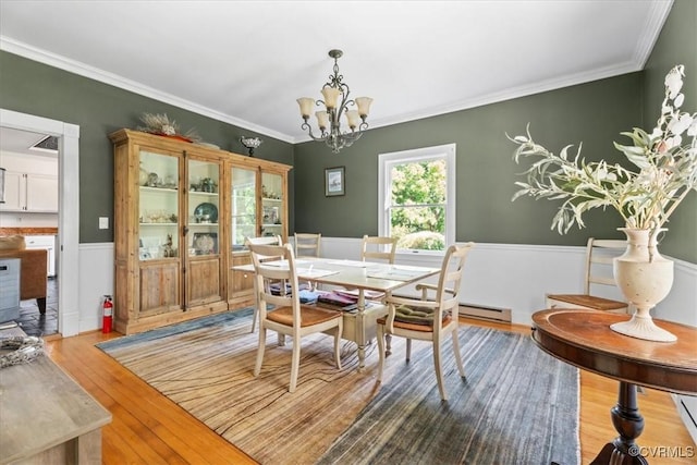 24405 N James Madison Hwy, New Canton, VA 23123 - dining area with a chandelier, wainscoting, wood finished floors, crown molding, and a baseboard heating unit