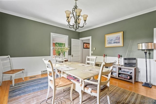 24405 N James Madison Hwy, New Canton, VA 23123 - dining space with a chandelier, wood finished floors, and crown molding