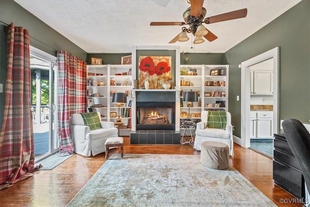 24405 N James Madison Hwy, New Canton, VA 23123 - living area featuring wood finished floors, a ceiling fan, and a tiled fireplace