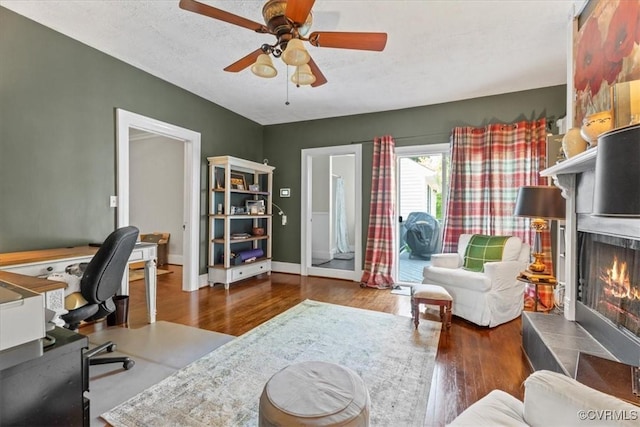 24405 N James Madison Hwy, New Canton, VA 23123 - office with a ceiling fan, wood finished floors, a warm lit fireplace, and baseboards