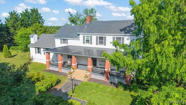 24405 N James Madison Hwy, New Canton, VA 23123 - back of property featuring a chimney, covered porch, a lawn, and metal roof