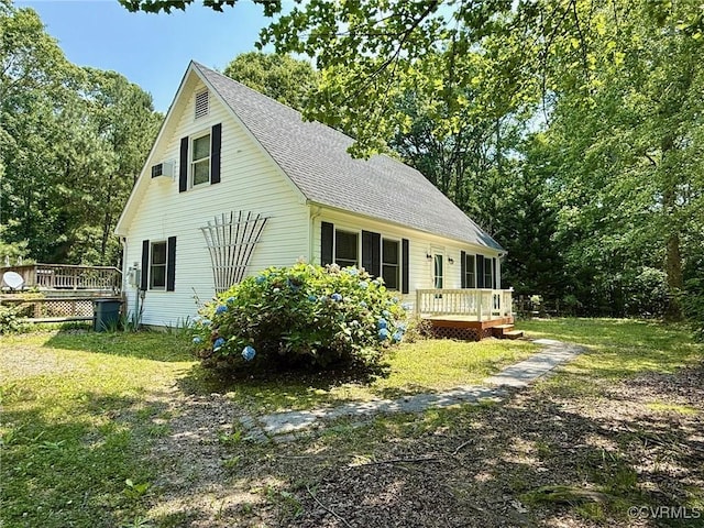 241 Levelfield Ln, Lancaster, VA 22503 - view of home's exterior with a wooden deck, a shingled roof, and a lawn