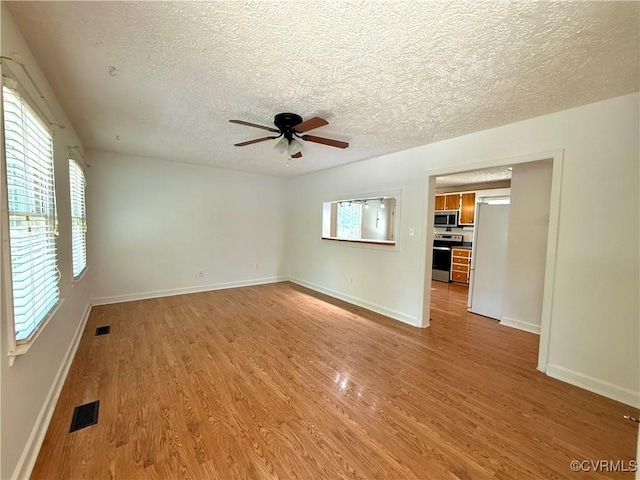 241 Levelfield Ln, Lancaster, VA 22503 - unfurnished room with light wood finished floors, a textured ceiling, ceiling fan, and baseboards