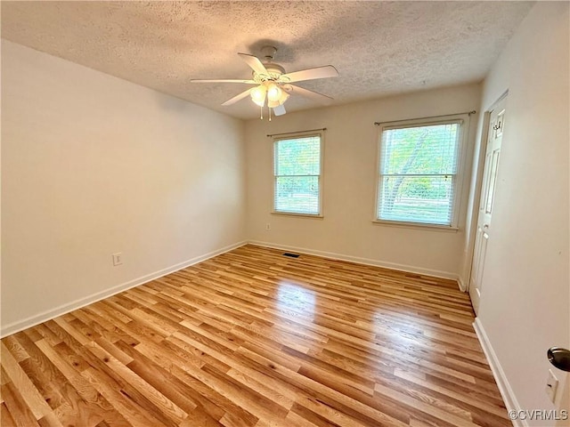 241 Levelfield Ln, Lancaster, VA 22503 - spare room with light wood-type flooring, a textured ceiling, ceiling fan, and baseboards