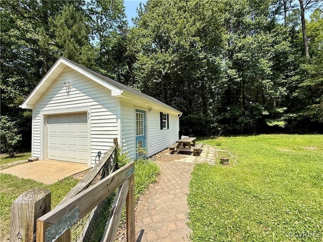241 Levelfield Ln, Lancaster, VA 22503 - view of grassy yard featuring an outdoor structure, a detached garage, and driveway