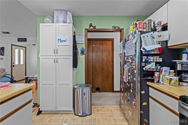 106 S Marion Ave Unit A, Hopewell, VA 23860 - kitchen with white cabinetry, wood counters, and brick patterned flooring