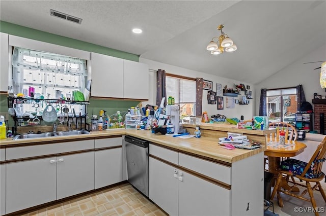 106 S Marion Ave Unit A, Hopewell, VA 23860 - kitchen with dishwasher, healthy amount of natural light, white cabinets, a peninsula, and vaulted ceiling