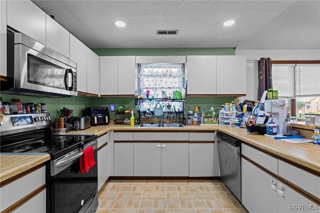 106 S Marion Ave Unit A, Hopewell, VA 23860 - kitchen featuring appliances with stainless steel finishes, a sink, light countertops, recessed lighting, and a textured ceiling