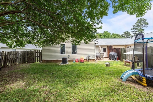 106 S Marion Ave Unit A, Hopewell, VA 23860 - rear view of house with a trampoline, central AC unit, and a patio