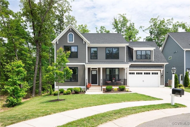 2401 Willowvale Pl, Midlothian, VA 23112 - view of front of property with covered porch, driveway, a garage, and a front lawn
