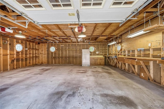 10108 Waltham Dr, Henrico, VA 23238 - garage featuring freestanding refrigerator and a garage door opener