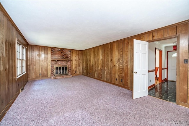 10108 Waltham Dr, Henrico, VA 23238 - unfurnished living room with wooden walls, carpet floors, a fireplace, and crown molding
