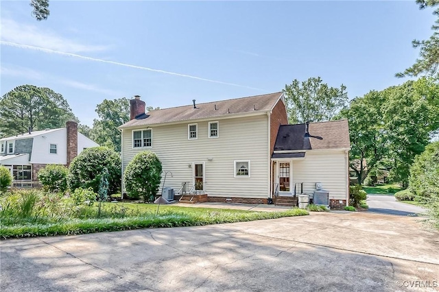 10108 Waltham Dr, Henrico, VA 23238 - back of house with a chimney and concrete driveway