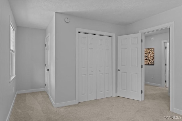 4709 Pompton Ln, Chester, VA 23831 - unfurnished bedroom featuring light carpet, baseboards, a closet, and a textured ceiling