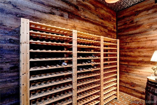 1921 Miln House Rd, Williamsburg, VA 23185 - wine room with wooden walls and brick patterned flooring