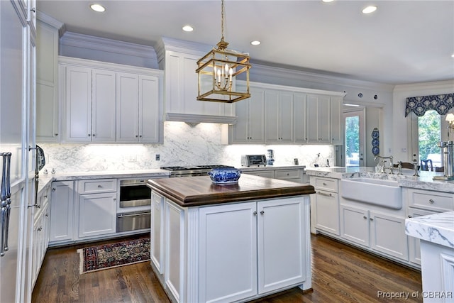 1921 Miln House Rd, Williamsburg, VA 23185 - kitchen with wood counters, a warming drawer, a kitchen island, a chandelier, and a sink