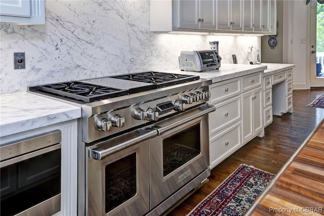 1921 Miln House Rd, Williamsburg, VA 23185 - kitchen featuring double oven range, decorative backsplash, white cabinets, and dark wood finished floors