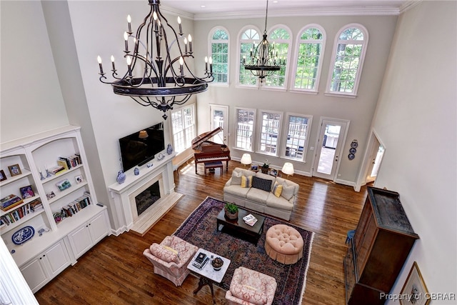 1921 Miln House Rd, Williamsburg, VA 23185 - living area featuring a chandelier, plenty of natural light, ornamental molding, dark wood-style floors, and a towering ceiling