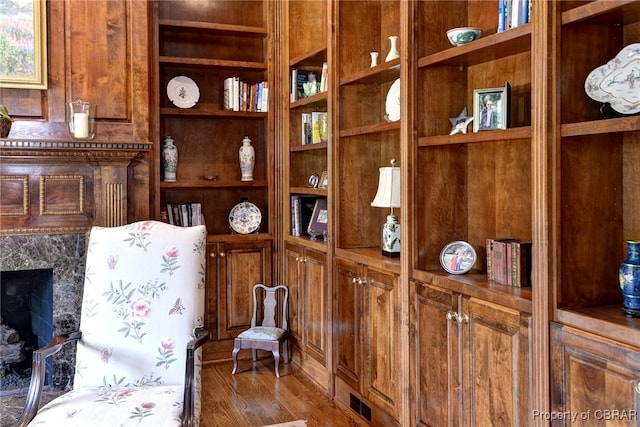 1921 Miln House Rd, Williamsburg, VA 23185 - sitting room with wood finished floors, built in features, and a high end fireplace