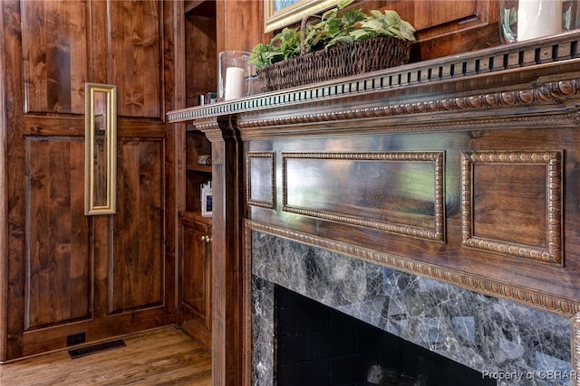 1921 Miln House Rd, Williamsburg, VA 23185 - detailed view of a premium fireplace, wood walls, and wood finished floors