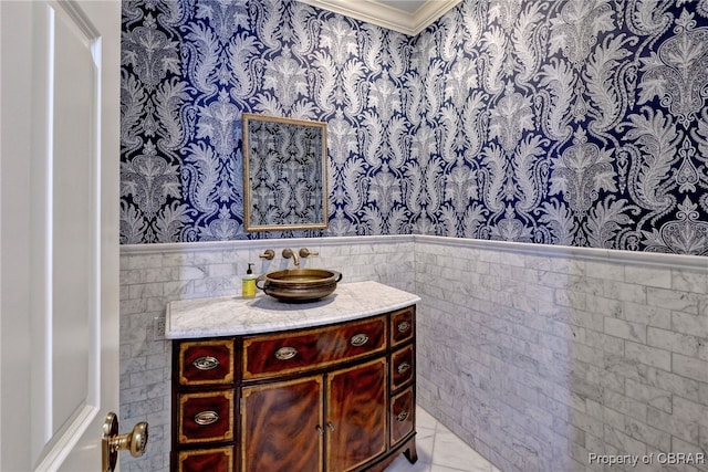 1921 Miln House Rd, Williamsburg, VA 23185 - bathroom featuring wainscoting, vanity, ornamental molding, tile walls, and wallpapered walls