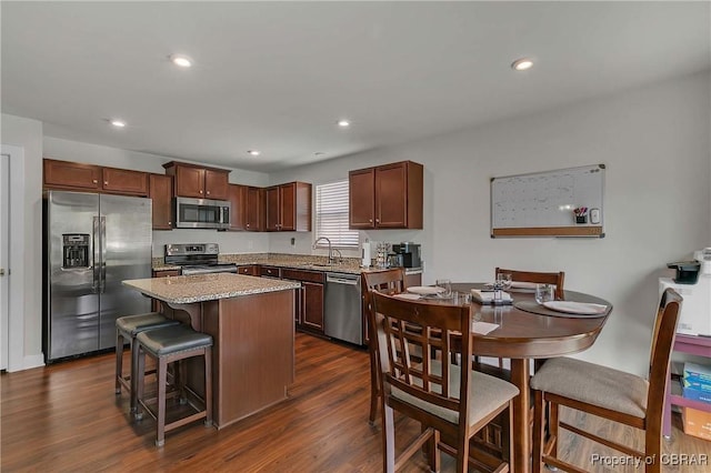 202 Arbordale Loop, Williamsburg, VA 23188 - kitchen featuring appliances with stainless steel finishes, dark wood-type flooring, a kitchen island, a breakfast bar, and recessed lighting