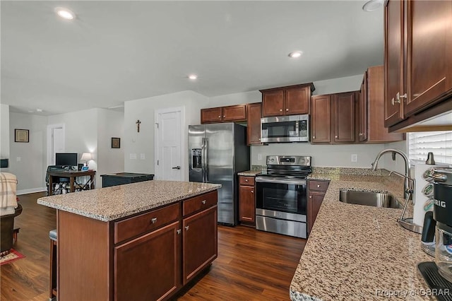 202 Arbordale Loop, Williamsburg, VA 23188 - kitchen featuring appliances with stainless steel finishes, a sink, dark wood finished floors, a center island, and light stone countertops