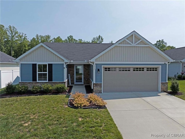202 Arbordale Loop, Williamsburg, VA 23188 - view of front facade featuring stone siding, an attached garage, driveway, and a front lawn