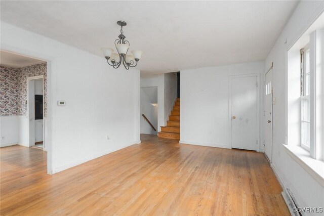 8005 Three Chopt Rd, Henrico, VA 23229 - spare room with light wood finished floors, a chandelier, stairs, baseboard heating, and baseboards