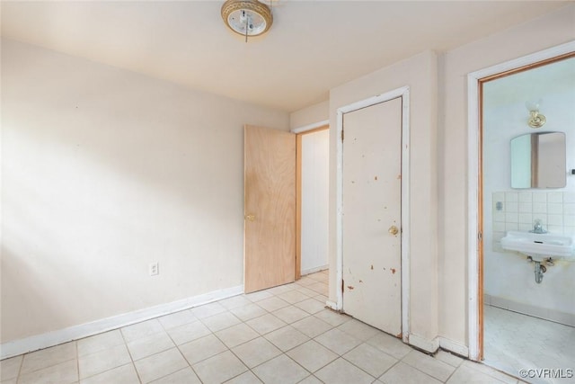 8005 Three Chopt Rd, Henrico, VA 23229 - unfurnished bedroom with baseboards, light tile patterned floors, and a sink