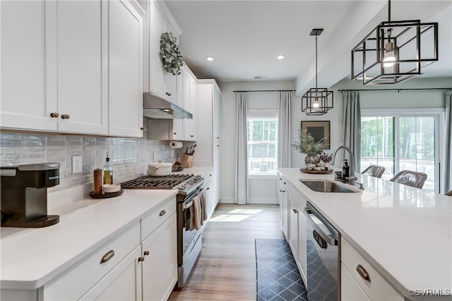 18342 Magnolia Run Ln, Moseley, VA 23120 - kitchen featuring stainless steel appliances, under cabinet range hood, decorative backsplash, white cabinetry, and light countertops