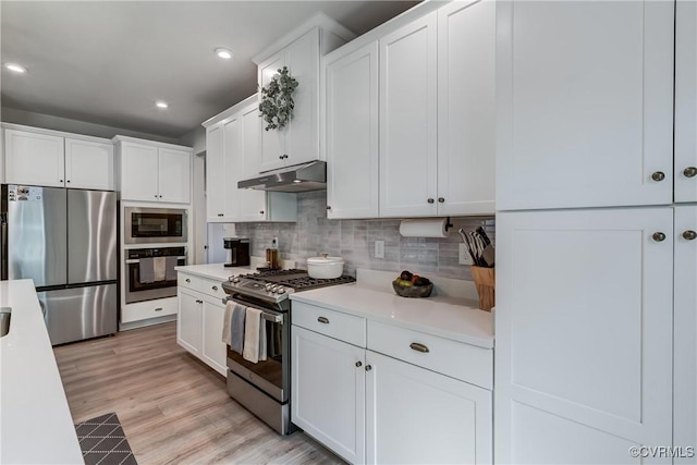 18342 Magnolia Run Ln, Moseley, VA 23120 - kitchen featuring stainless steel appliances, under cabinet range hood, light countertops, tasteful backsplash, and white cabinets