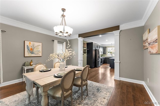 3104 1st Ave, Richmond, VA 23222 - dining space featuring ornate columns, dark wood finished floors, ornamental molding, baseboards, and a chandelier